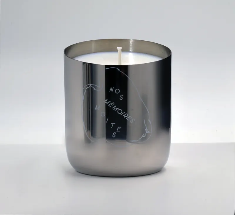 Nos Mémoires Moites candle in its steel vessel